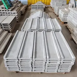 imagem de um galpão com diversas pingadeiras de concreto pré-fabricadas empilhadas em cima de um pallet